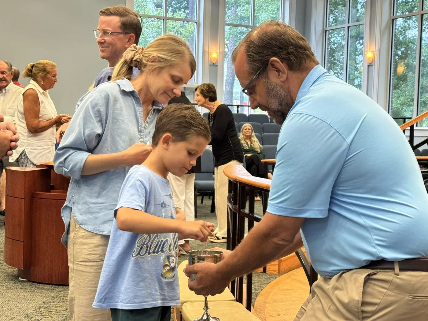 A young boy receiving Communion with his family at Christ Church Bluffton