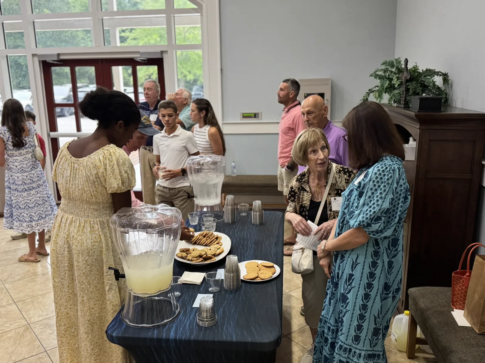Church members gathering for cookies and lemonade during fellowship at Christ Church Bluffton