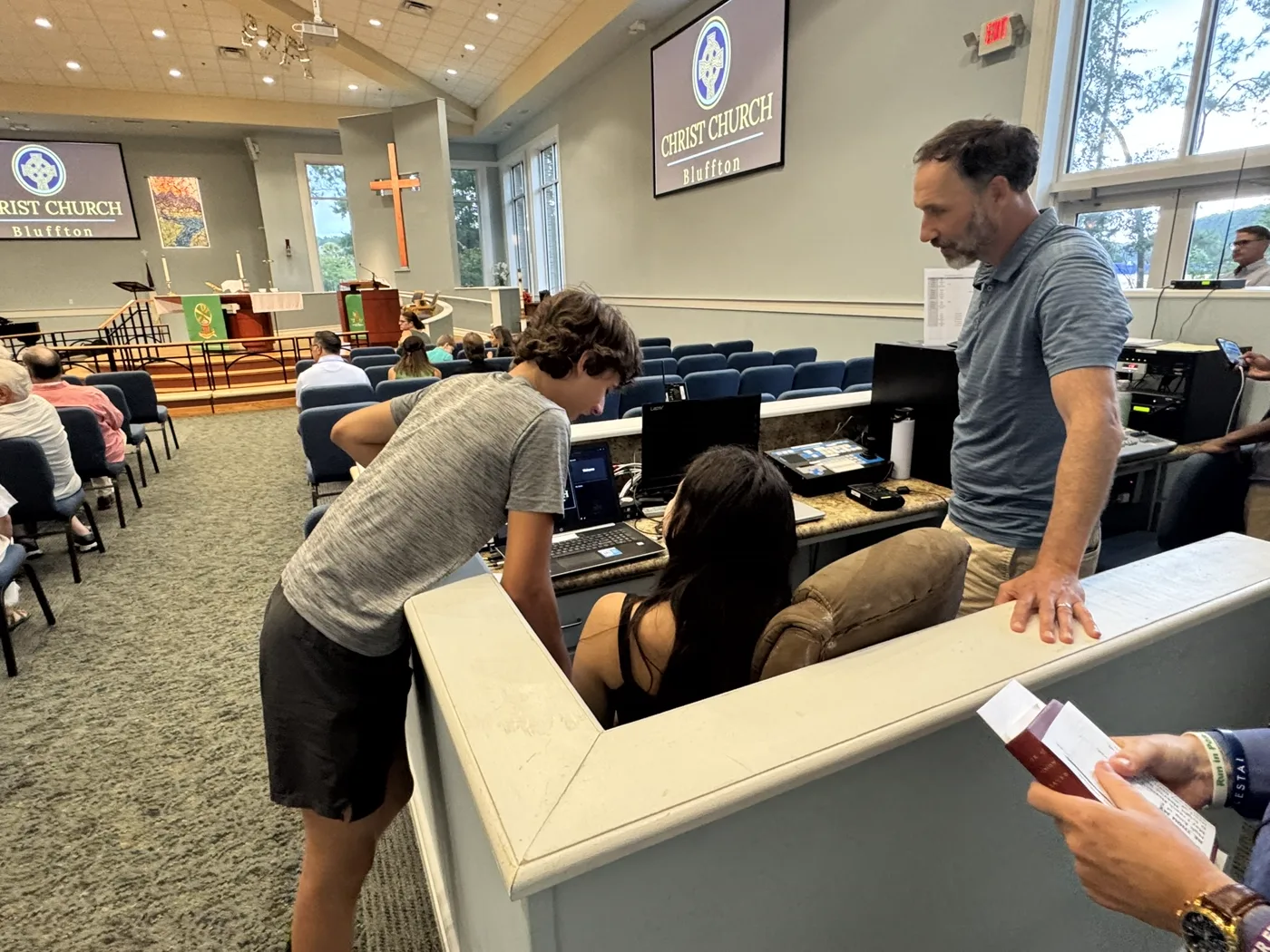 A family helping run the sound and tech booth during a service at Christ Church Bluffton